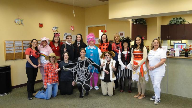 a group posing in halloween costumes